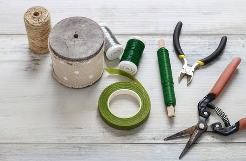 floral tools laid out including trimmers, floral wire, floral tape and twine