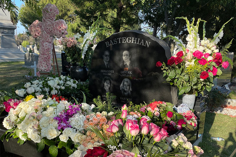 Grave of Hovanes Basteghian and family covered with flowers