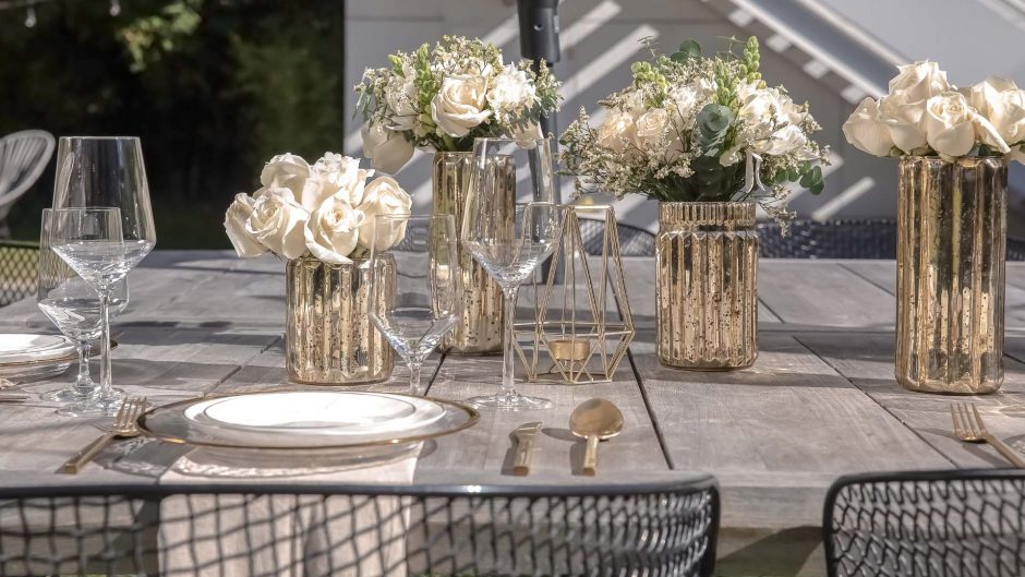 four white wedding centerpieces on a wedding table