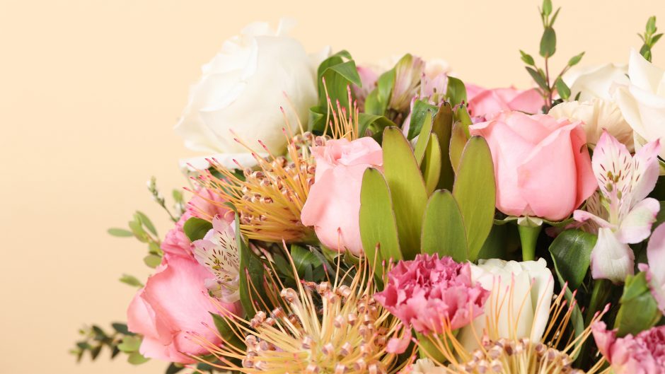 close up image of white and pink flower bouquet with pincushion