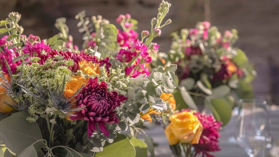 close up of purple and yellow flowers with greenery