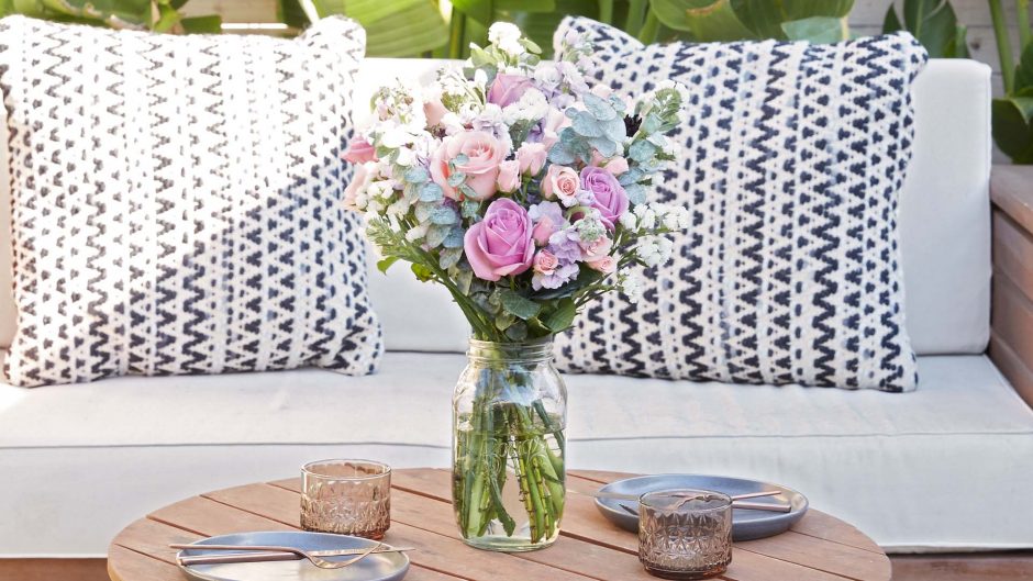 purple and pink flowers on a table outdoors