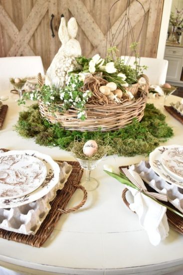 Easter basket centerpiece with flowers and a bunny statue