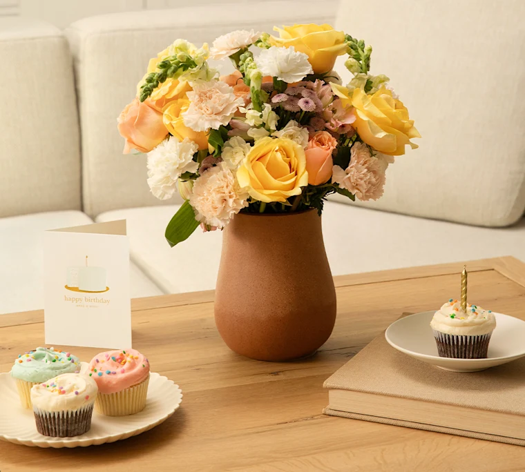Buttercream bouquet in vase with cupcakes