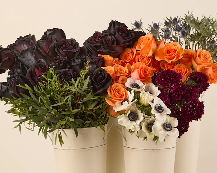 loose stems of halloween colored flowers in buckets