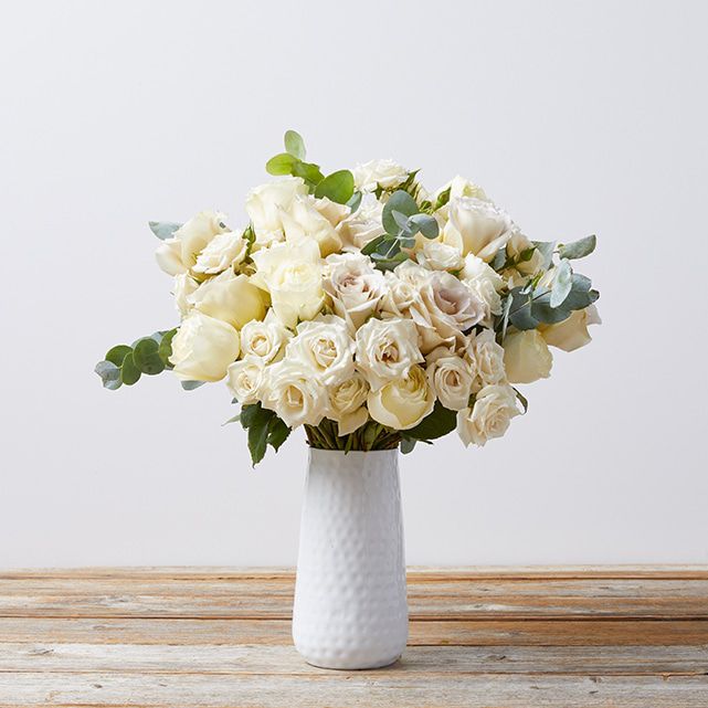 A white bouquet in a white vase.