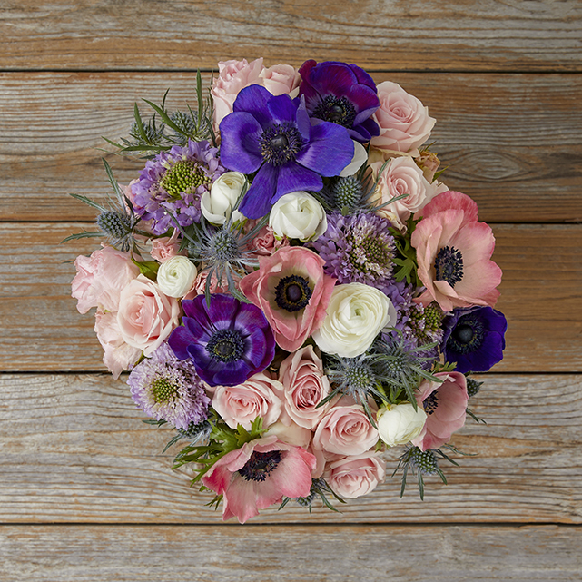 Bouquet featuring pink and purple anemones and ranunculus