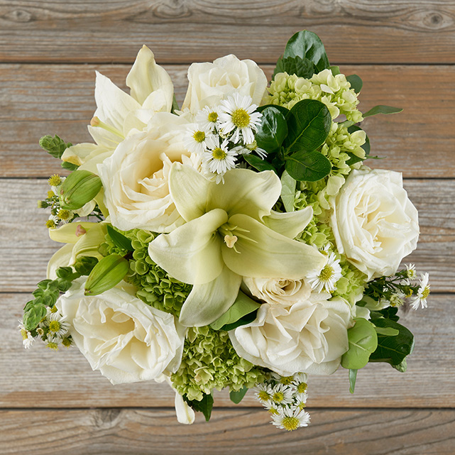 white snapdragons, roses and lilies with mini lime green hydrangea flowers