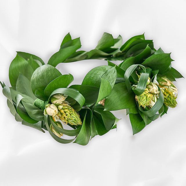 a flower crown with greenery and white blooms