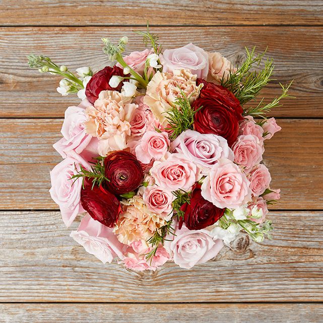 Floral arrangement with red elegance ranunculus, blush roses and pink spray roses. 4