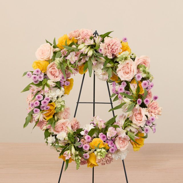 mixed floral wreath in yellow, white, pink and other pastel colors