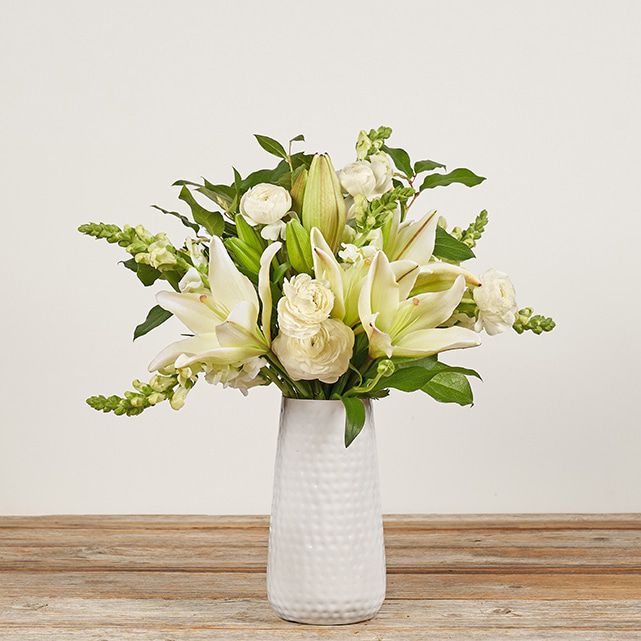 White Lilies and Ranunculus With Greenery Accents - The Bouqs Co.