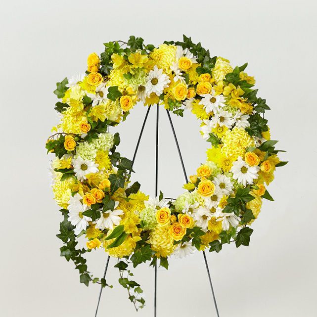 Funeral standing wreath with mixed white and yellow flowers