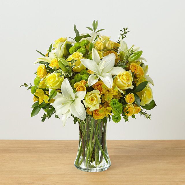 Vased arrangement of yellow and white mixed flowers